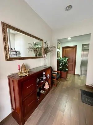 a living room with a mirror and a wooden dresser at Piso en pleno centro de Miño izquierda in Miño