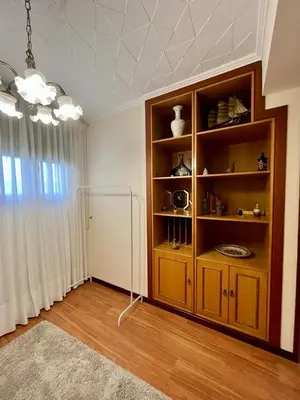 a room with a book shelf with vases on it at Piso en pleno centro de Miño izquierda in Miño