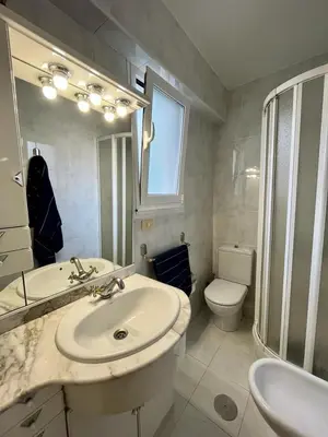 a bathroom with a sink and a toilet and a mirror at Piso en pleno centro de Miño izquierda in Miño