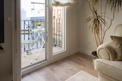 a living room with a door leading to a balcony at Bonito y luminoso apartamento en Rosalía de Castro in Santiago de Compostela