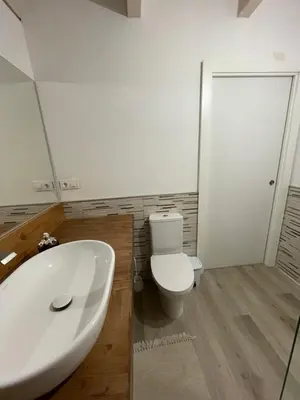 a bathroom with a white sink and a toilet at As Fontaiñas in Beiro