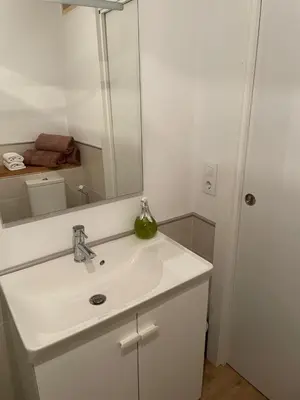a bathroom with a white sink and a mirror at As Fontaiñas in Beiro