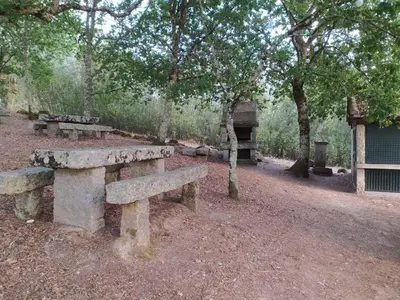 a group of stone benches in a park at As Fontaiñas in Beiro