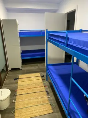 a room with two bunk beds and a rug at Vagabond Vieiras Beds & Communal Dinner Included Albergue LE-210 in La Portela de Valcarce