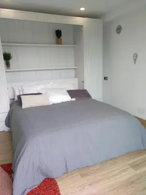 a bedroom with a large bed in a room at Casa Rocha Velha con terraza y piscina particular in Santiago de Compostela