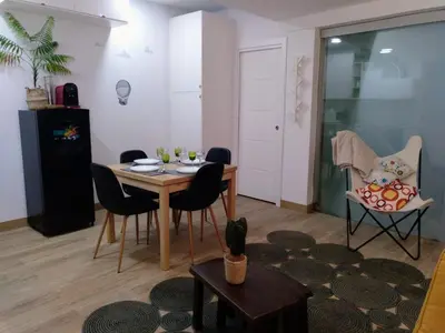 a living room with a table and chairs at Casa Rocha Velha con terraza y piscina particular in Santiago de Compostela