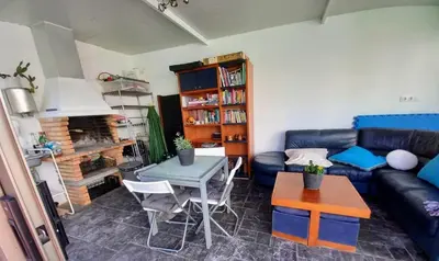 a living room with a blue couch and a table at Casa Rocha Velha con terraza y piscina particular in Santiago de Compostela