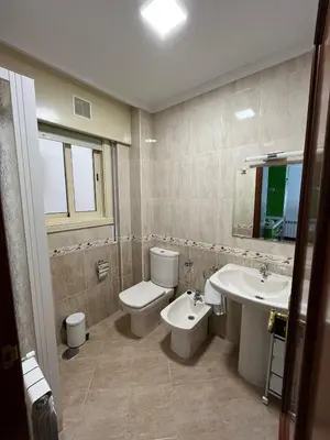 a bathroom with a toilet and a sink at Apartamento Marichu in Melide