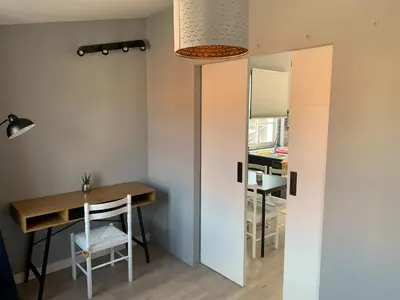 a small dining room with a table and a desk at NOARU Apartamentos in Ares