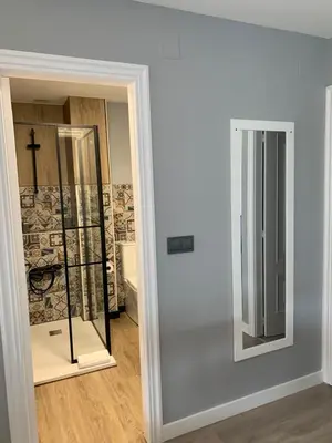 a mirror in a room with a cross on the wall at NOARU Apartamentos in Ares