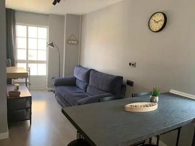 a living room with a couch and a table at NOARU Apartamentos in Ares