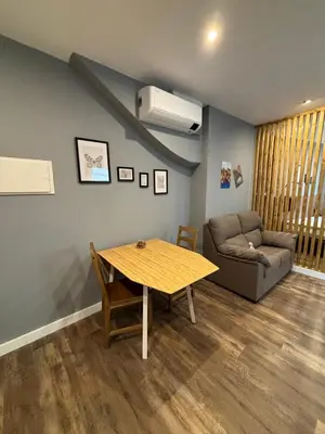 a living room with a table and a couch at NOARU Apartamentos in Ares
