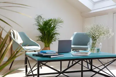 a room with two chairs and a table with a laptop at Hotel Trina 20 in Palas de Rei