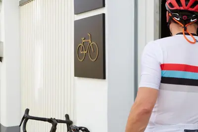 a man wearing a bike helmet standing in front of a wall at Hotel Trina 20 in Palas de Rei