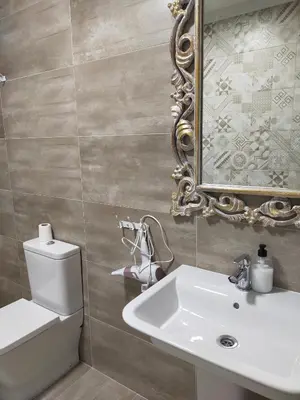 a bathroom with a white sink and a mirror at Arzúa Centro Vivienda de uso turístico in Arzúa
