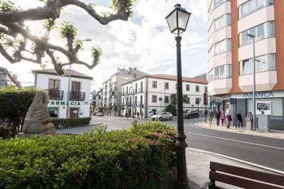 a street light on a city street with buildings at Arzúa Centro Vivienda de uso turístico in Arzúa