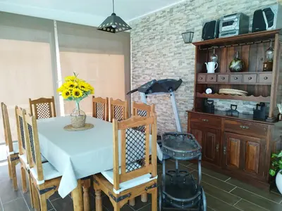 a dining room with a table with a vase of flowers at Casa Fina in Foz