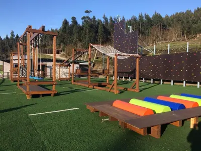 a playground with colorful chairs in a park at Glamping Aventura Atalaia in Cotobade