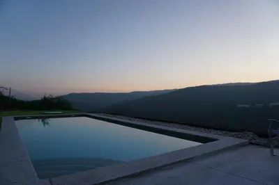 a swimming pool with a view of the mountains at Glamping Aventura Atalaia in Cotobade