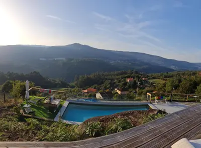 a swimming pool with a view of a mountain at Glamping Aventura Atalaia in Cotobade