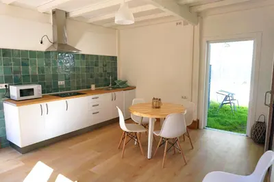 a kitchen and dining room with a table and chairs at Glamping Aventura Atalaia in Cotobade