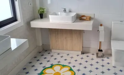 a bathroom with a sink and a bathroom floor at Glamping Aventura Atalaia in Cotobade