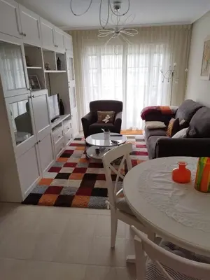 a living room with a couch and a table at COSTA REINANTE SPA Y PISCINA in San Miguel de Reinante