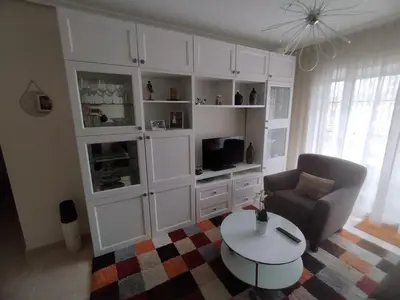 a living room with a couch and a table at COSTA REINANTE SPA Y PISCINA in San Miguel de Reinante