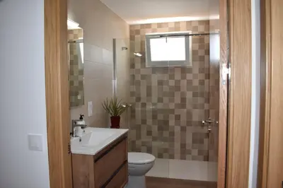 a bathroom with a sink and a toilet and a window at Vivienda de Uso Turístico ABELLA in Matarrosa del Sil
