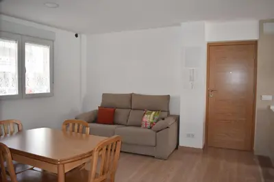 a living room with a couch and a table at Vivienda de Uso Turístico ABELLA in Matarrosa del Sil