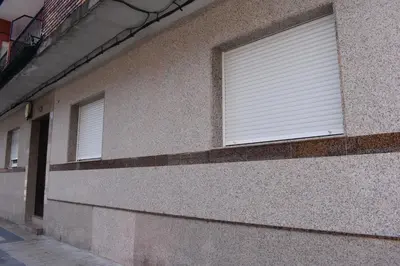 a window with blinds on the side of a building at Vivienda de Uso Turístico ABELLA in Matarrosa del Sil