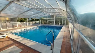 a swimming pool with a canopy over it at VILLA DAVID in Horta