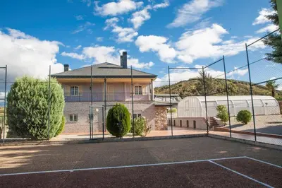 a tennis court in front of a building at VILLA DAVID in Horta