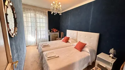 a bedroom with a large white bed with red pillows at VILLA DAVID in Horta