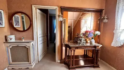 a bathroom with a mirror and a table with flowers on it at VILLA DAVID in Horta