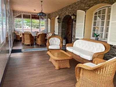 a living room with wicker chairs and a couch at VILLA DAVID in Horta