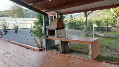 a outdoor kitchen with a wood stove on a patio at VILLA DAVID in Horta