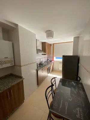 a kitchen with a table and chairs in a room at dpCristal Calvo Sotelo 164, 4D in Sarria