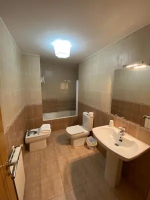 a bathroom with two toilets and a sink and a mirror at dpCristal Calvo Sotelo 164, 4D in Sarria