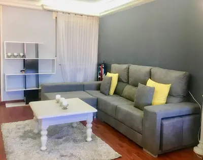 a living room with a couch and a coffee table at Apartamento Lugo Centro in Lugo