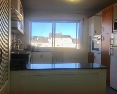 a kitchen with a large window and a counter top at Apartamento Lugo Centro in Lugo