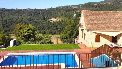 a house with a swimming pool next to a building at Casa A mi Vera in Covelo