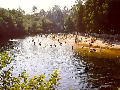 a group of people on a beach in the water at Casa A mi Vera in Covelo