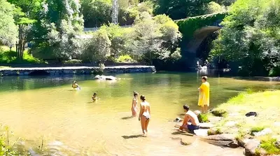 a group of people in the water in a river at Casa A mi Vera in Covelo