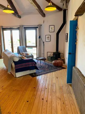 a living room with a bed and a fireplace at Farm house in Ribeira Sacra in O Carballo