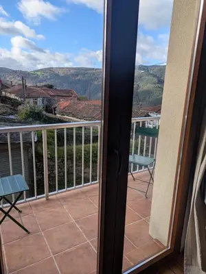 a balcony with a view of the mountains at Farm house in Ribeira Sacra in O Carballo