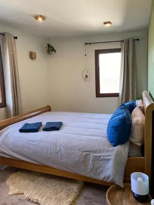 a bedroom with a bed with blue pillows on it at Farm house in Ribeira Sacra in O Carballo
