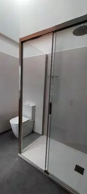 a glass shower in a bathroom with a toilet at O Souto da Aldea Ribeira Sacra Parada de Sil in Parada del Sil