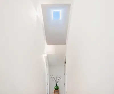 a stairway with a vase in a room at O Souto da Aldea Ribeira Sacra Parada de Sil in Parada del Sil