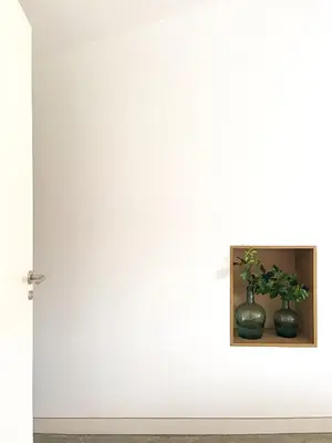 a white wall with two vases on a shelf at seixurra 31 in A Coruña